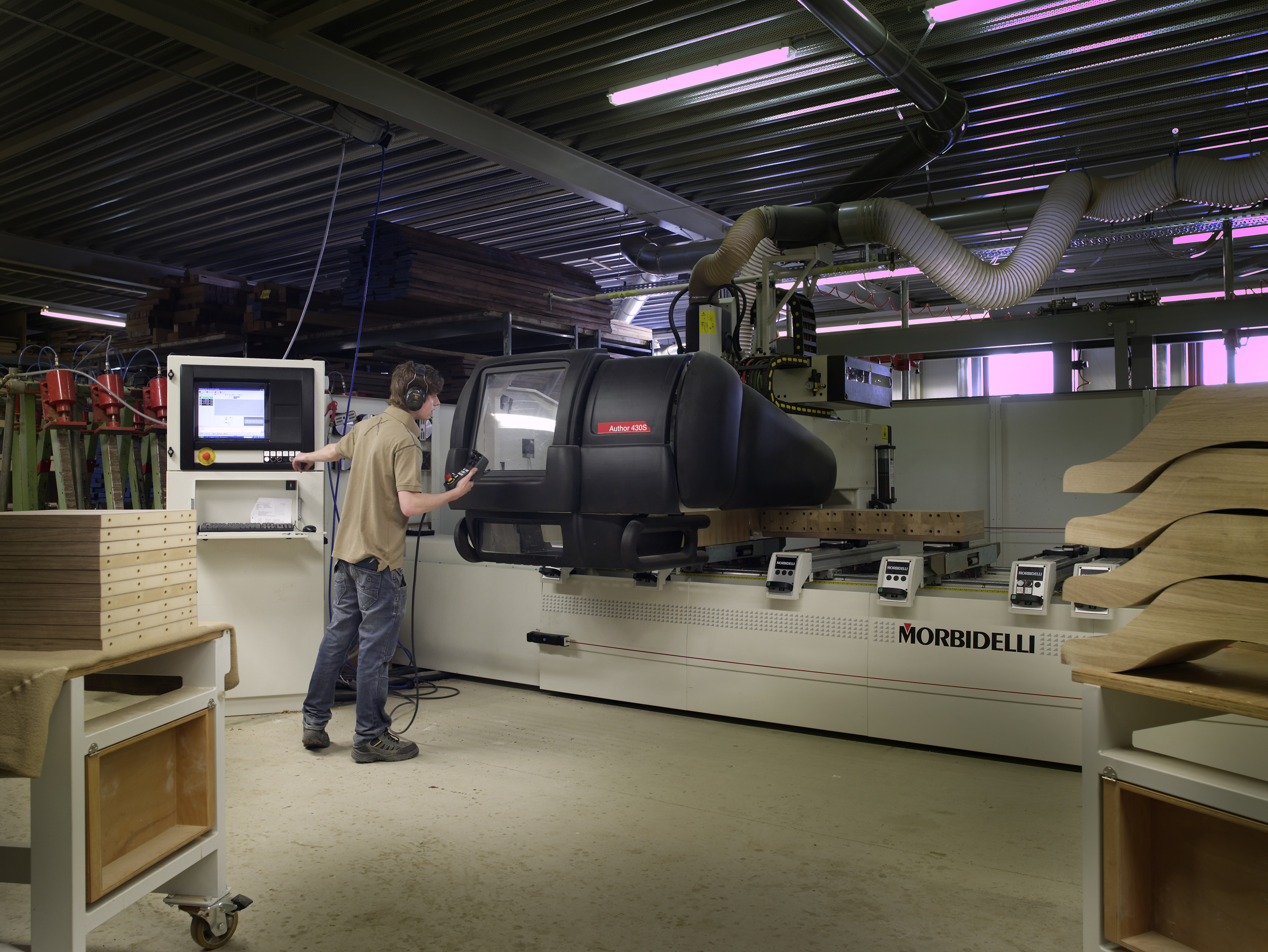 CNC training classroom with an instructor and trainees reviewing machine setup